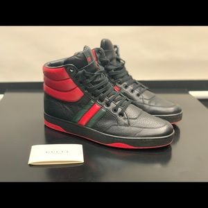 Gucci mid cut black, red, and green sneakers.